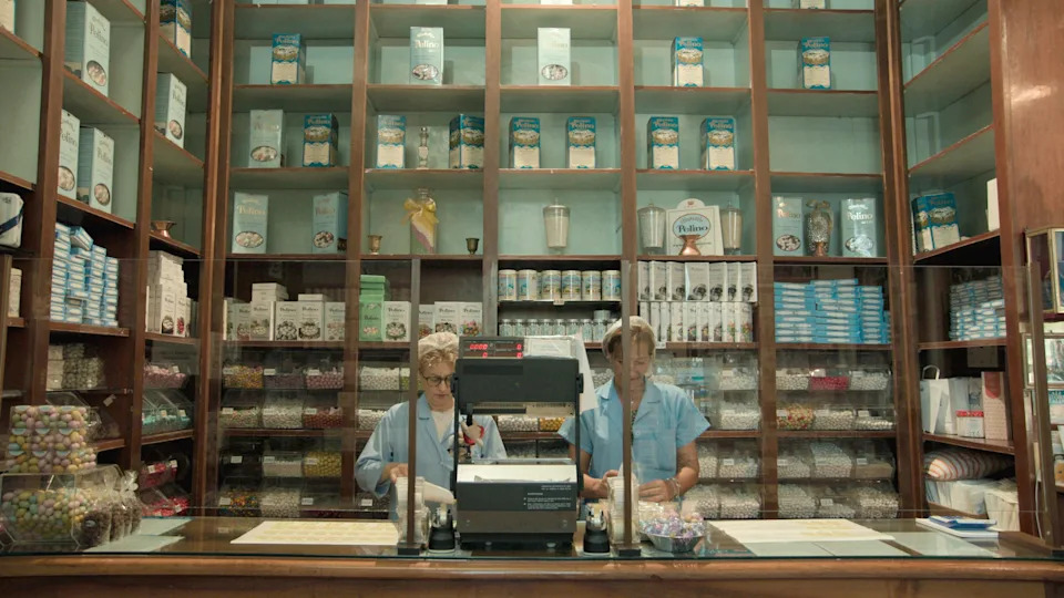 The Pelino shop interior, featuring two shop assistants in full attire, with confetti boxes in the background. 