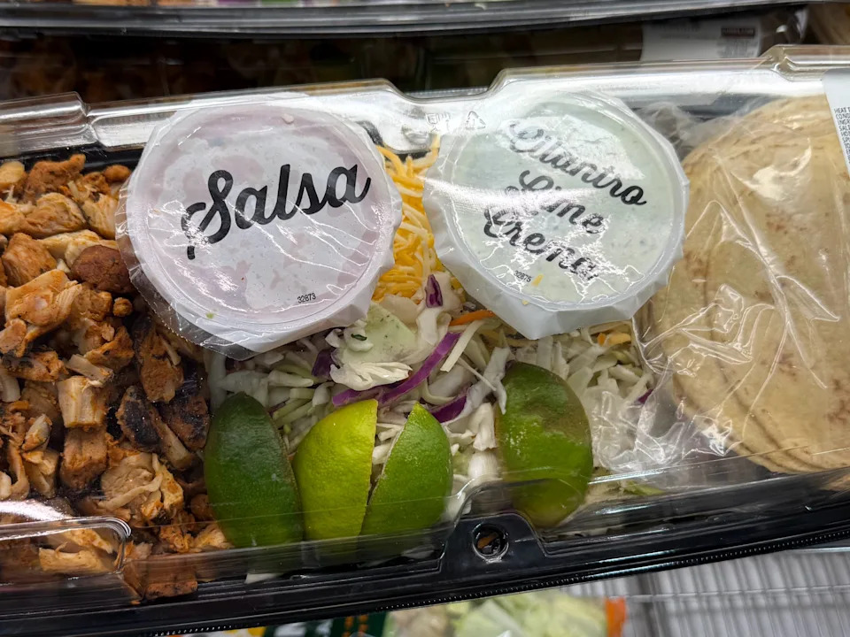 Costco's chicken street-taco kit with cups of salsa and cilantro lime crema.