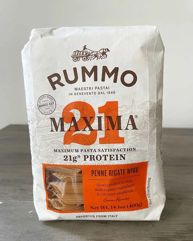Pasta package featuring Rummo Maxima Penne Rigate with 21g protein, showcasing a rustic design and Italian origin.