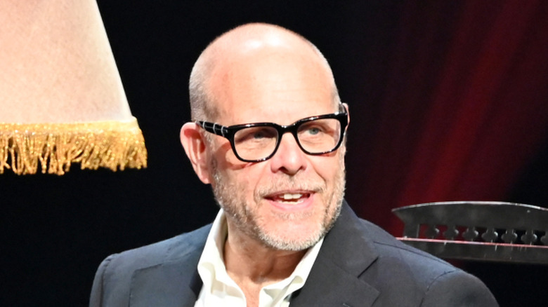 Alton Brown speaking and sitting on chair