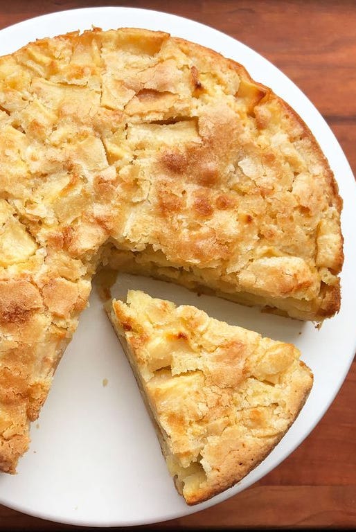 french apple custard cake with a slice missing
