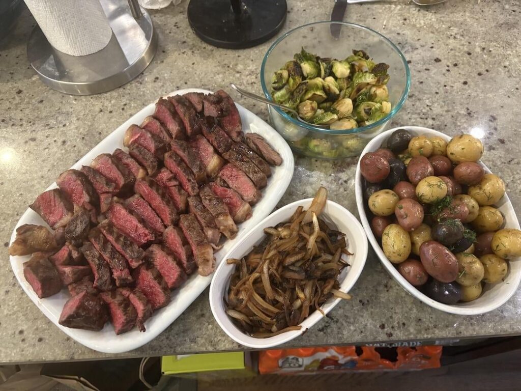 My son's request for his 17th birthday - NY strip, bacon fat brussels and small potatoes with dill from the garden