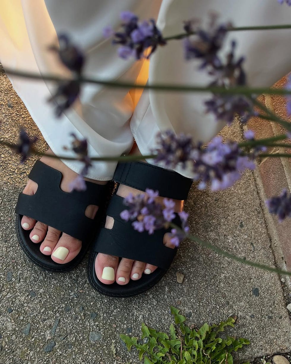 footwear displayed in a natural setting with floral accents butter yellow biab pedicure