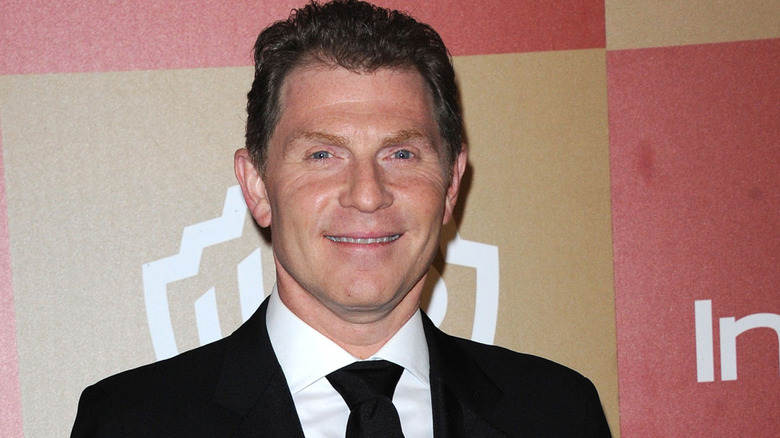 Bobby Flay smiling at red carpet event