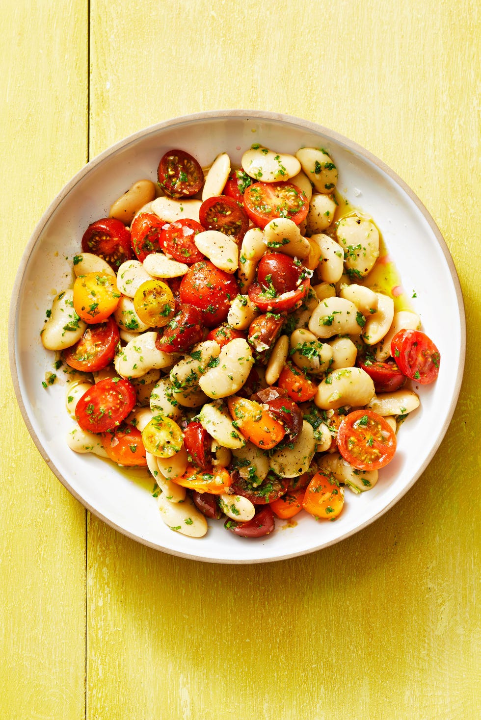 butter bean salad with herby vinaigrette on a white plate