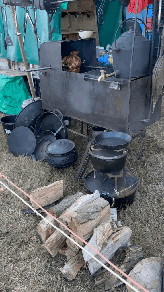 Turkey cook on the chuck wagon firebox. Cast iron kettle gives hot water.