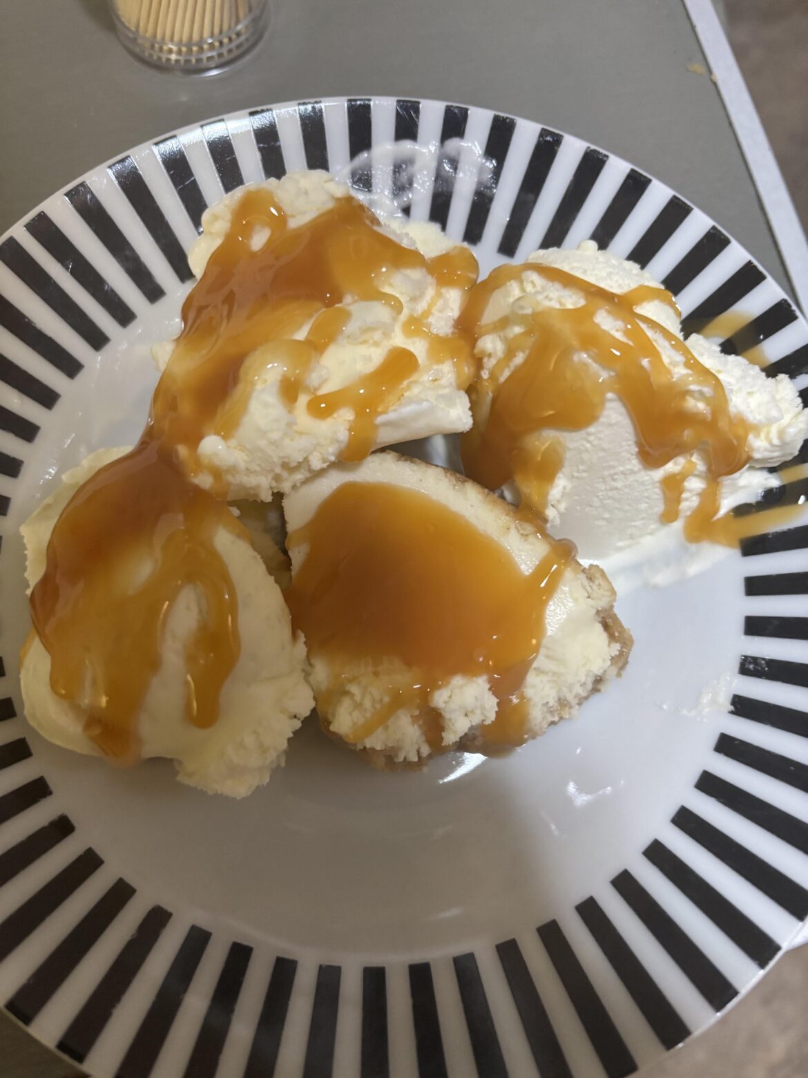 Cheesecake and ice cream with caramel sauce on top