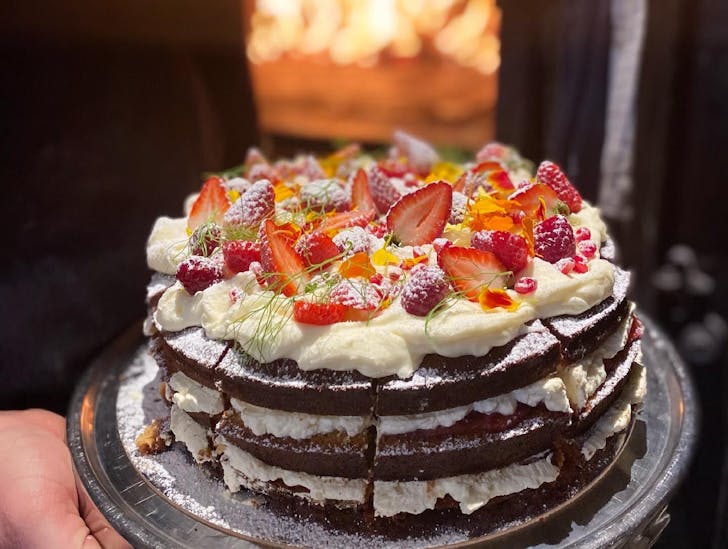 cake with cream and fruit on top