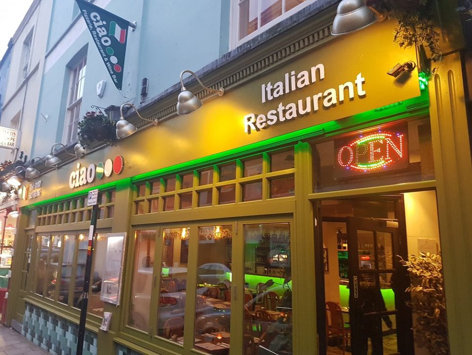Ciao Italian Restaurant storefront at night.