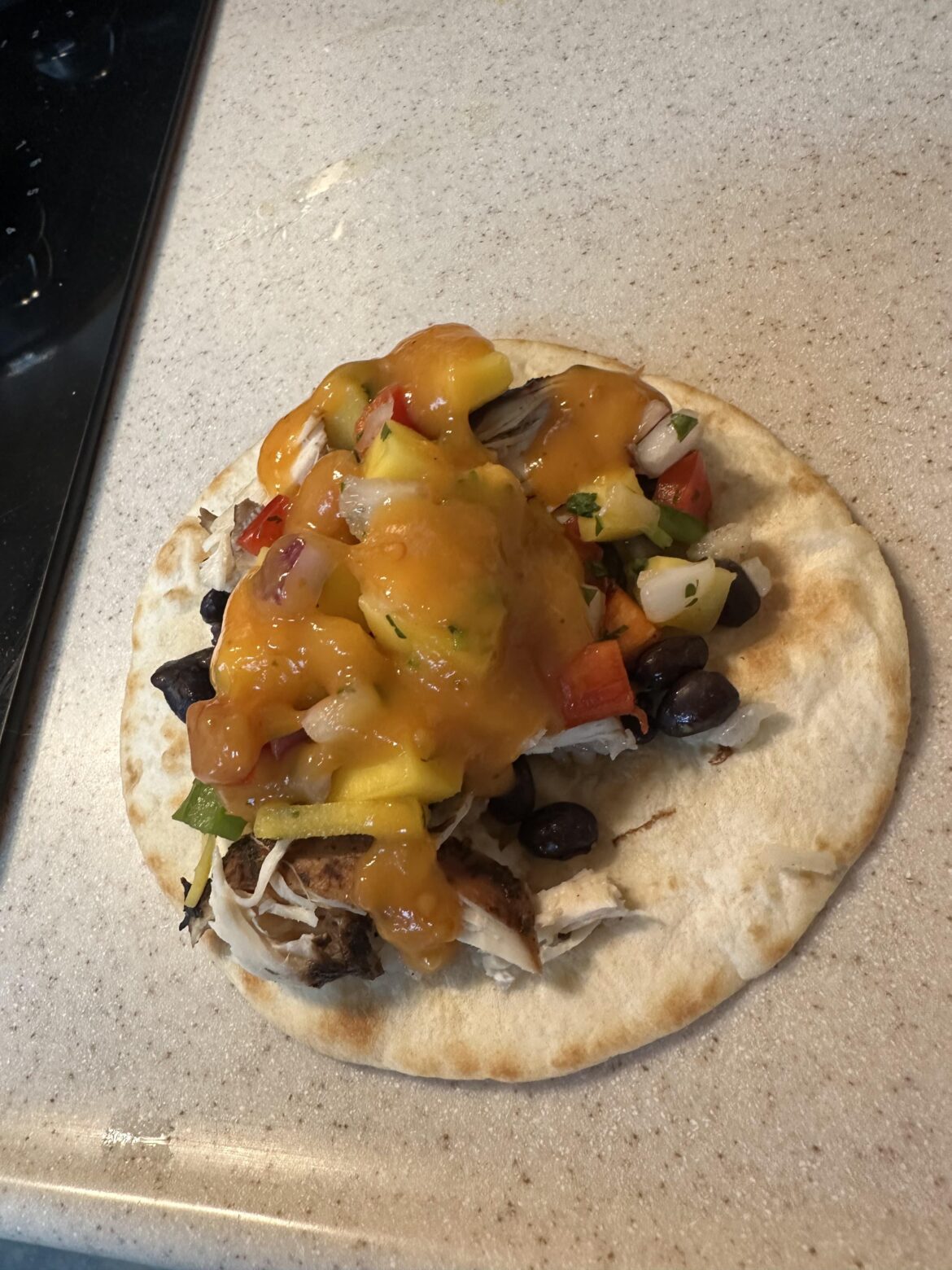 Jerk chicken tacos with veggie-coconut rice, black beans, mango pico de gallo, and Trader Joe’s Habanero hot sauce