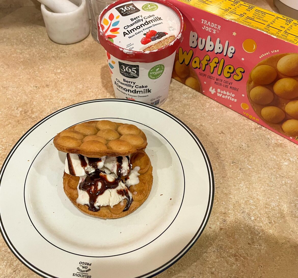 Vegan bubble waffle ice cream sandwich with berry chantilly cake ice cream and chocolate sauce