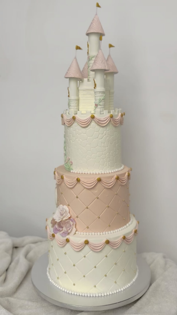 Princess-themed castle cake in soft pink and white