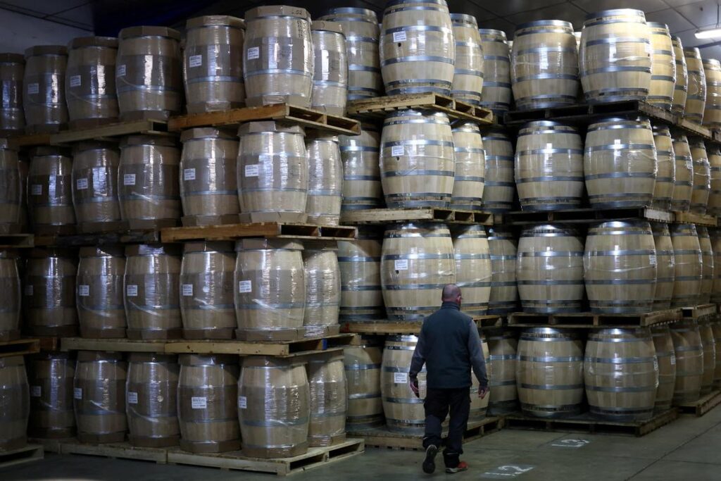 EU-US trade deal expected to confirm duty-free trade in spirits, French exporters say FILE PHOTO: An employee walks past oak barrels at the Tonnelleries Vicard cooperage in Cognac, France, April 3, 2025. REUTERS/Stephane Mahe/File Photo