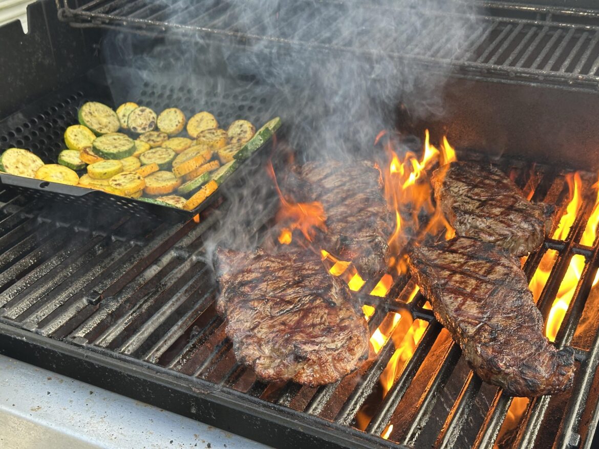 Steaks on the grill with some zucchini from our garden