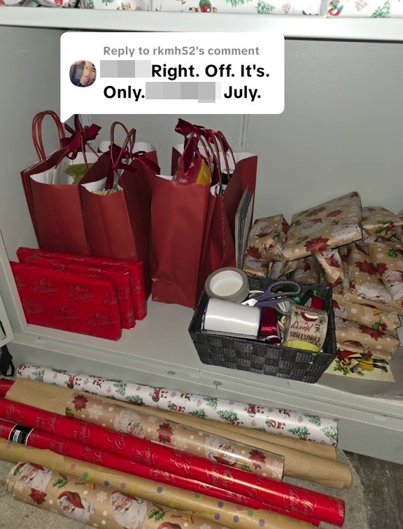 Christmas gifts and wrapping supplies stored in a cupboard in July.