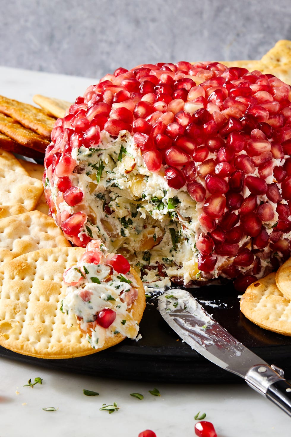 fancy christmas cheese ball covered in pomegranate seeds