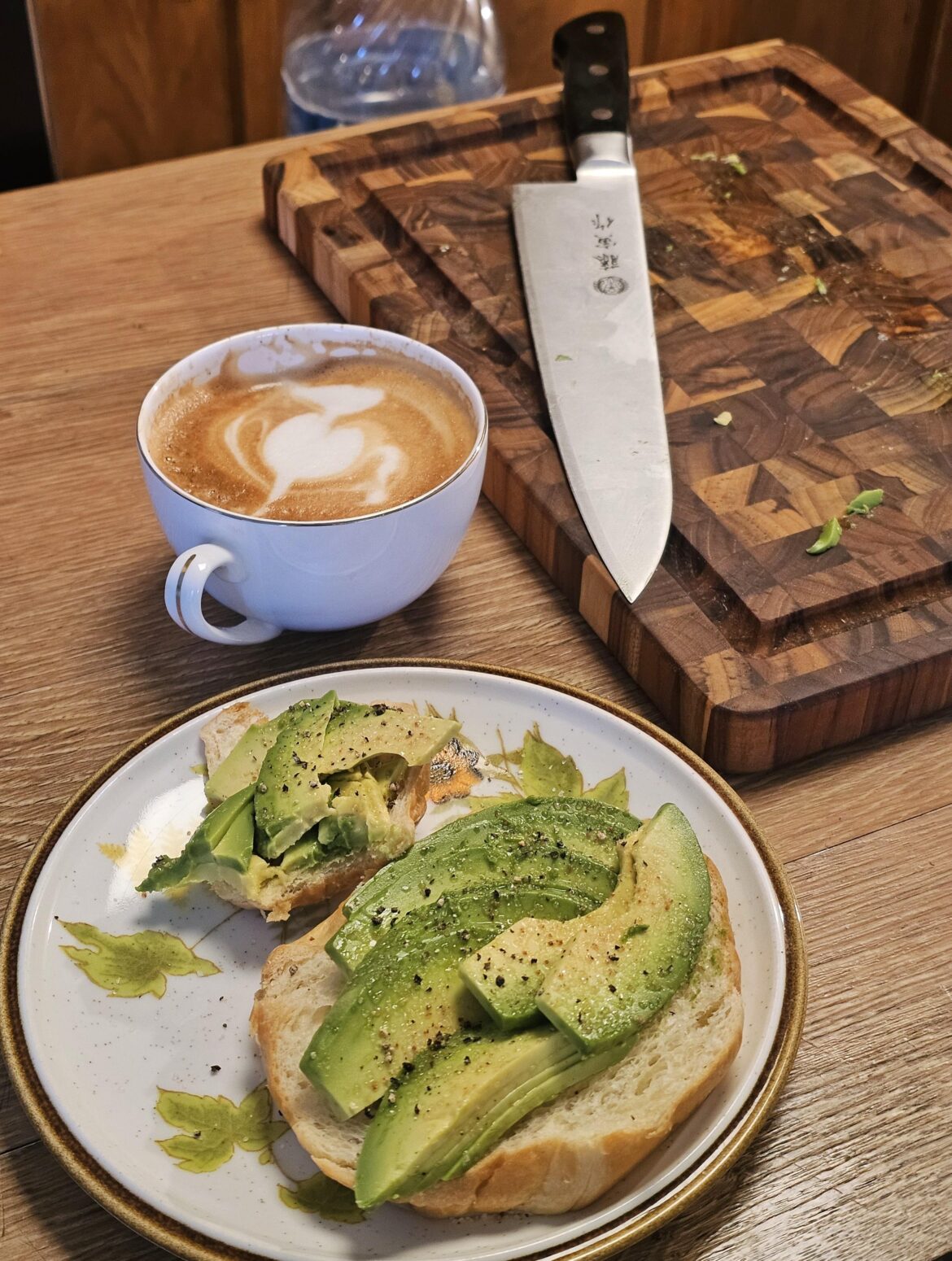 Simple avocado on croissant and cappuccino