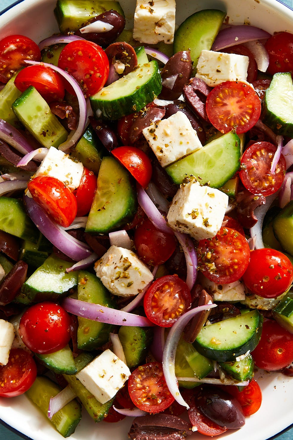 greek salad with cucumber, tomatoes, red onion, olives, and feta