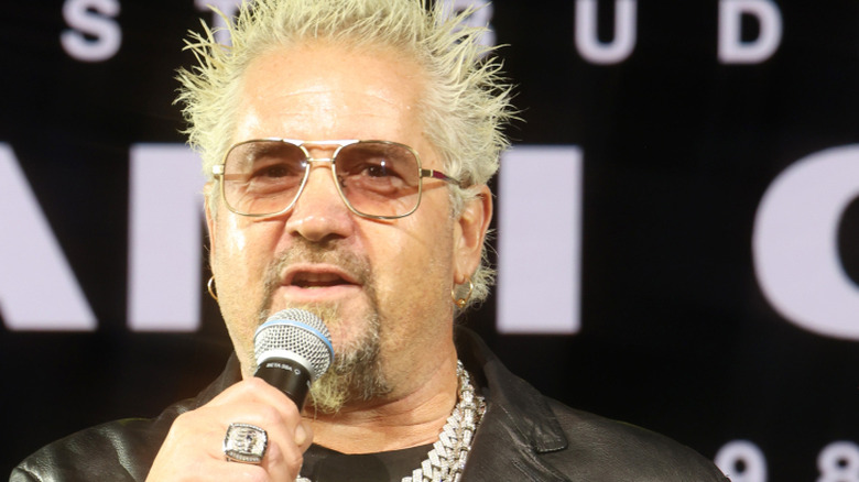 Guy Fieri speaking into a microphone