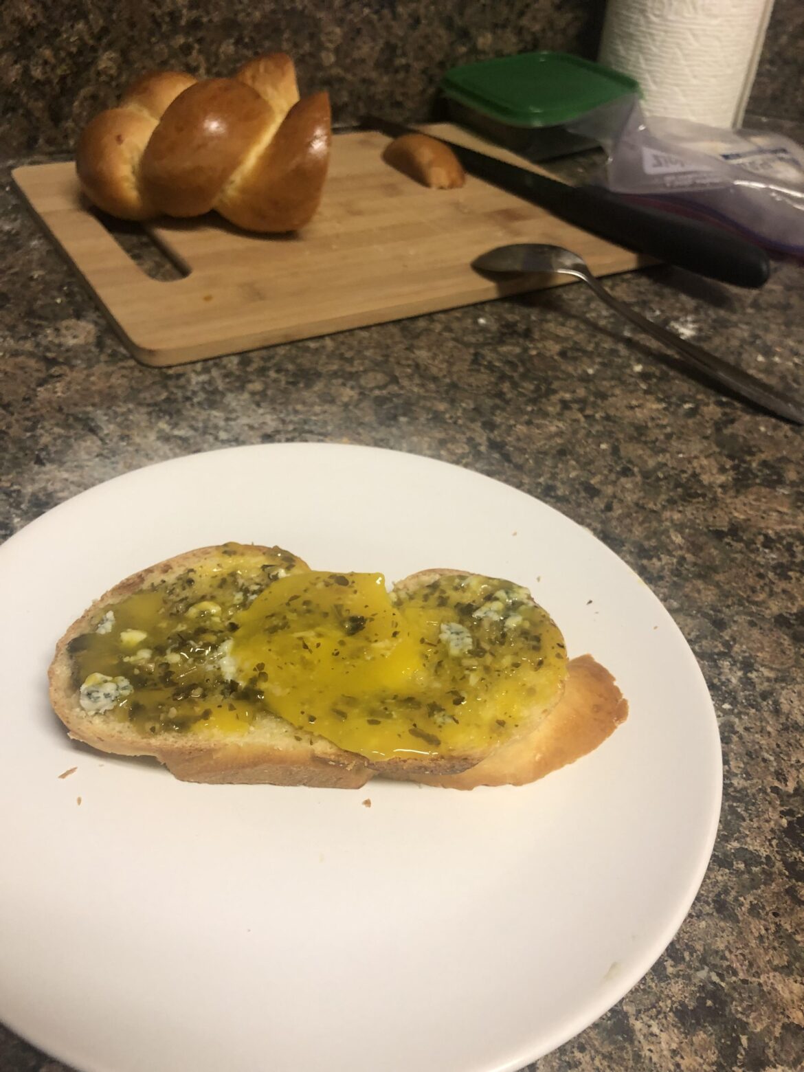 Tried poaching but lost the whites, so I spread the yolk instead. Homemade bread with pesto and blue cheese.