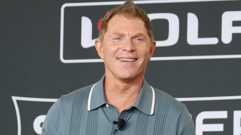 Chef Bobby Flay smiling during a cooking presentation