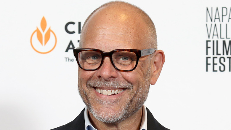 alton brown wearing glasses and smiling