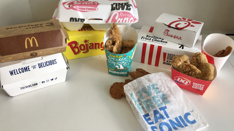 10 different types of fast food chicken tenders in boxes and bags