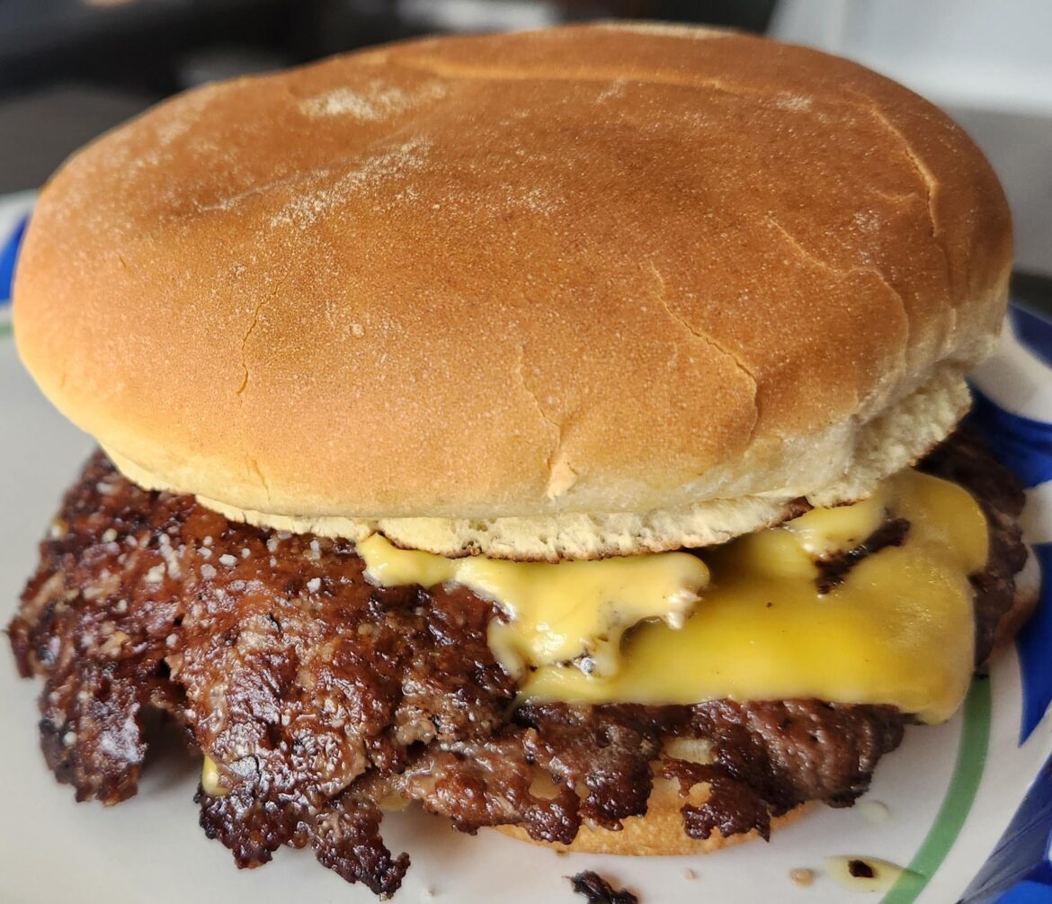 First smash burger on stainless steel