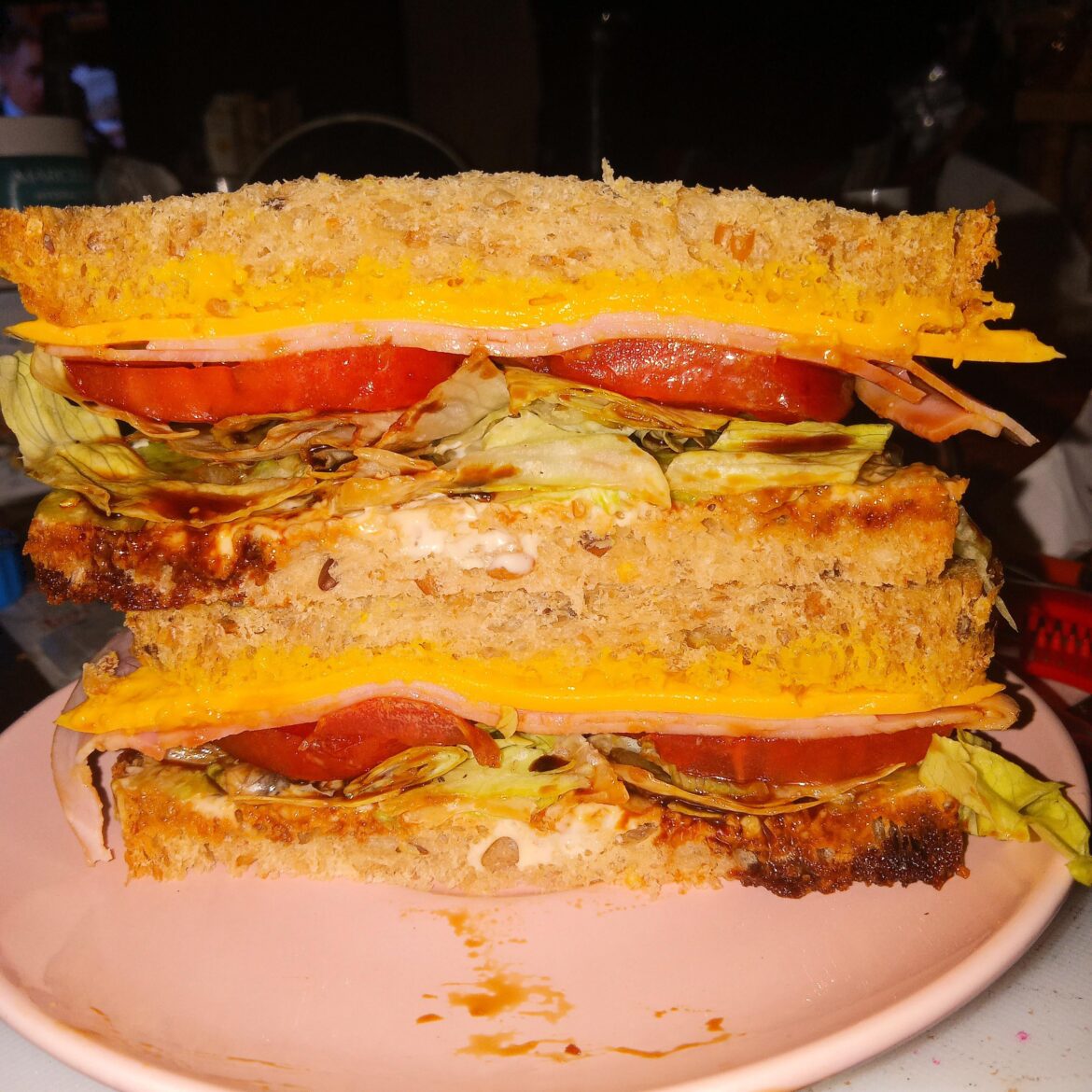 Ham and cheese with lettuce and tomatoes on grain bread.