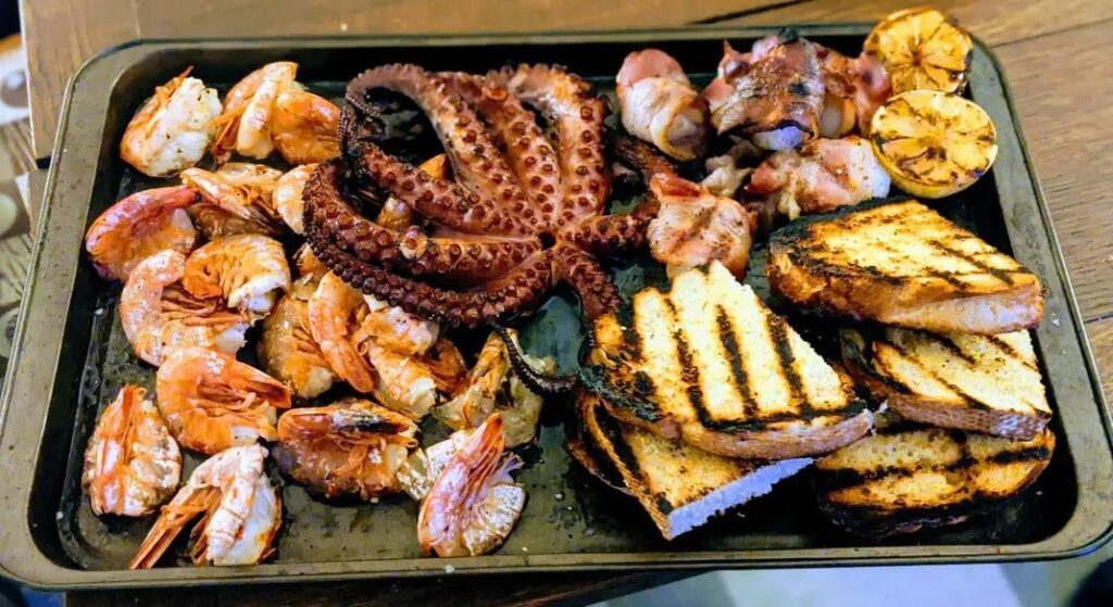 Grilled up a seafood feast. Shrimp, scallops, and octopus. With homemade bread.