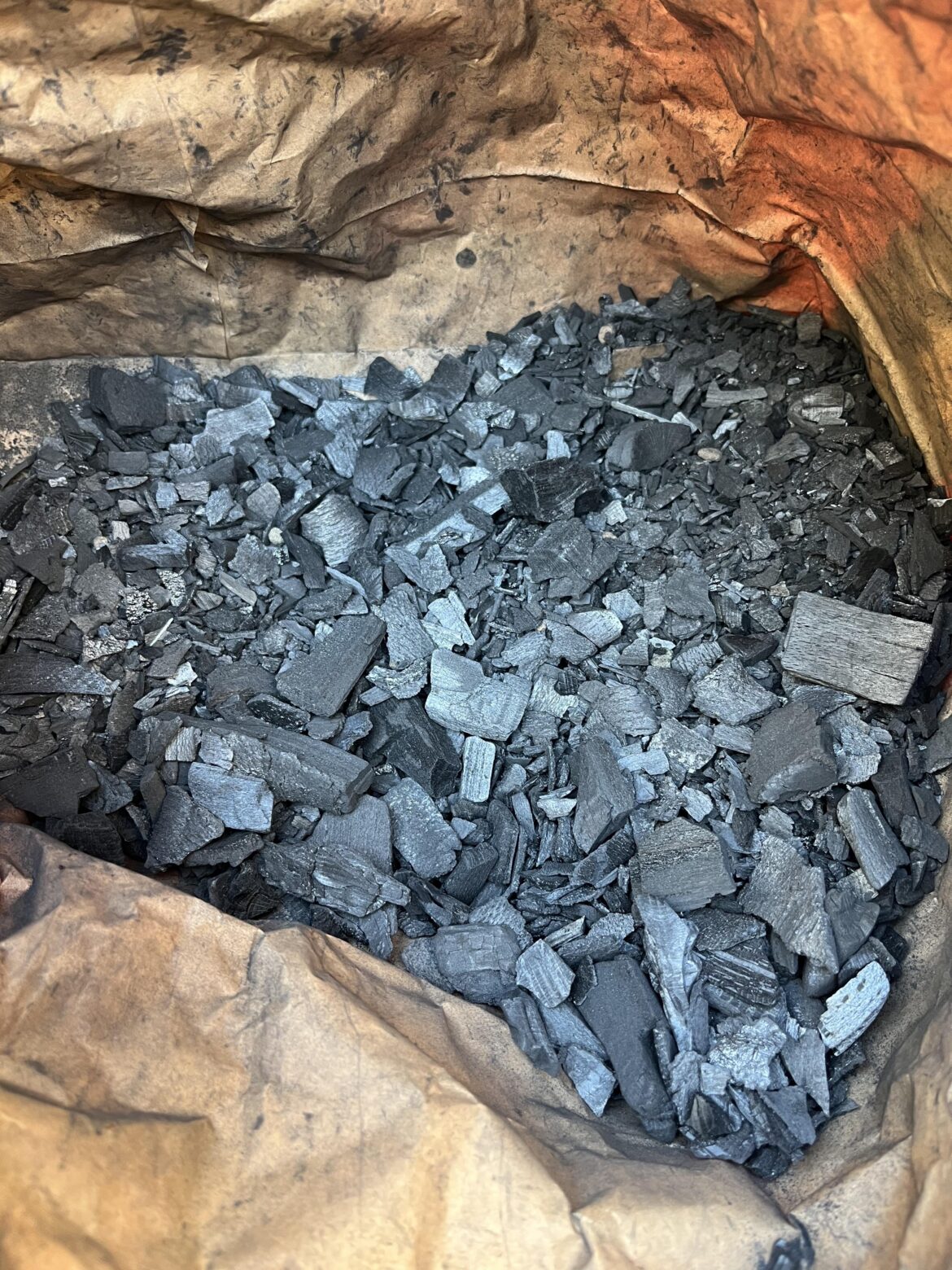 What in tarnation are y’all supposed to do with that sad little pile of charcoal crumbs at the bottom of the bag??