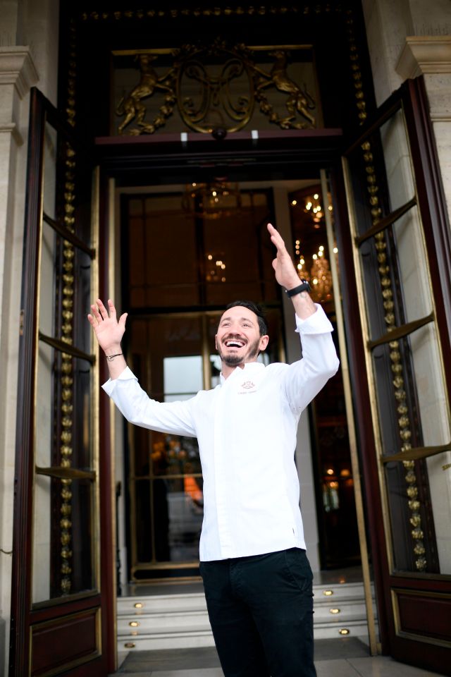 a man standing in front of a door with his arms outstretched