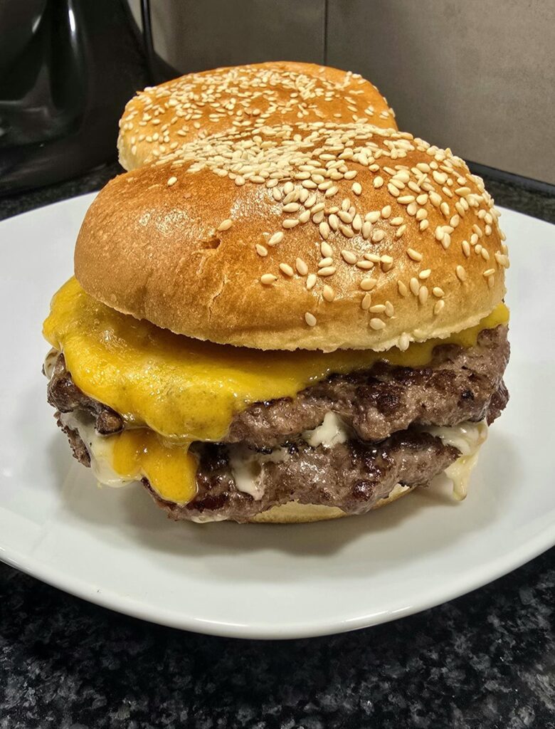 Homemade pan cheeseburger with grilled bacon and onions