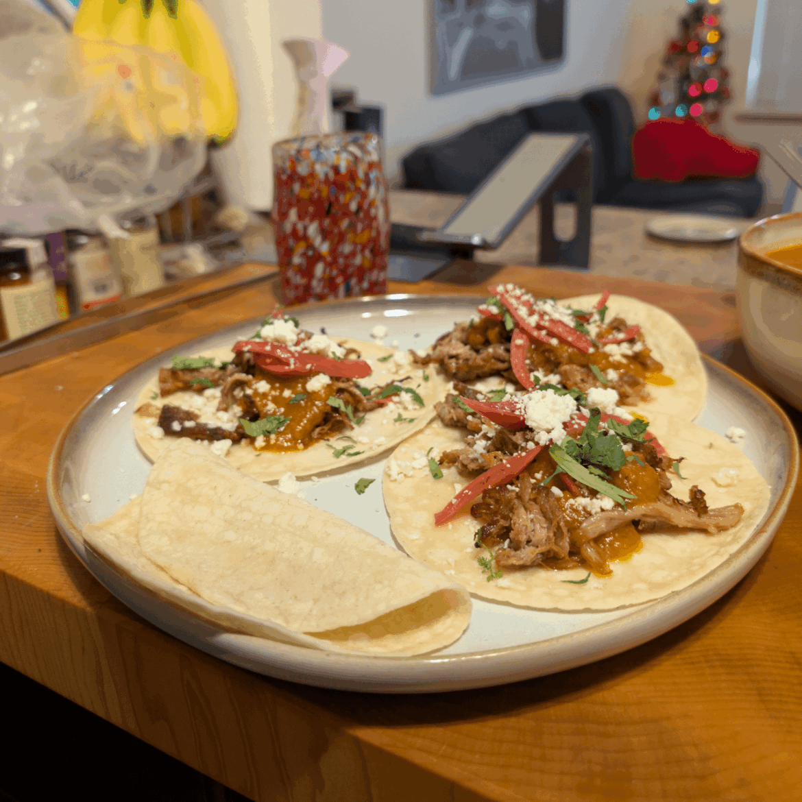 Pulled pork tacos with apricot-chipotle salsa, pickled red onions, cotija, and cilantro