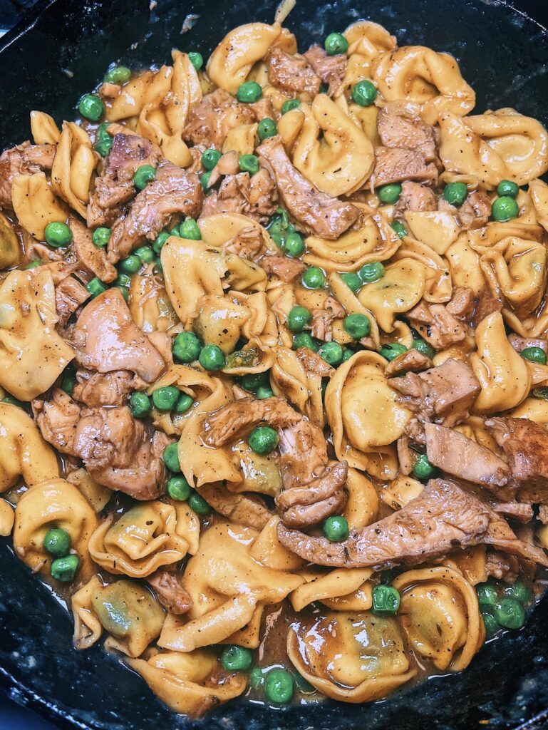 Clean out the fridge meal : tortellini with peas & chicken thighs in a caramelized onion sauce.