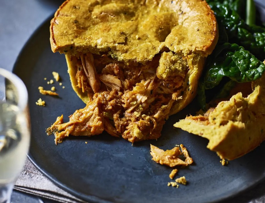 Tesco Christmas food: a partially eaten chicken pie with greens.