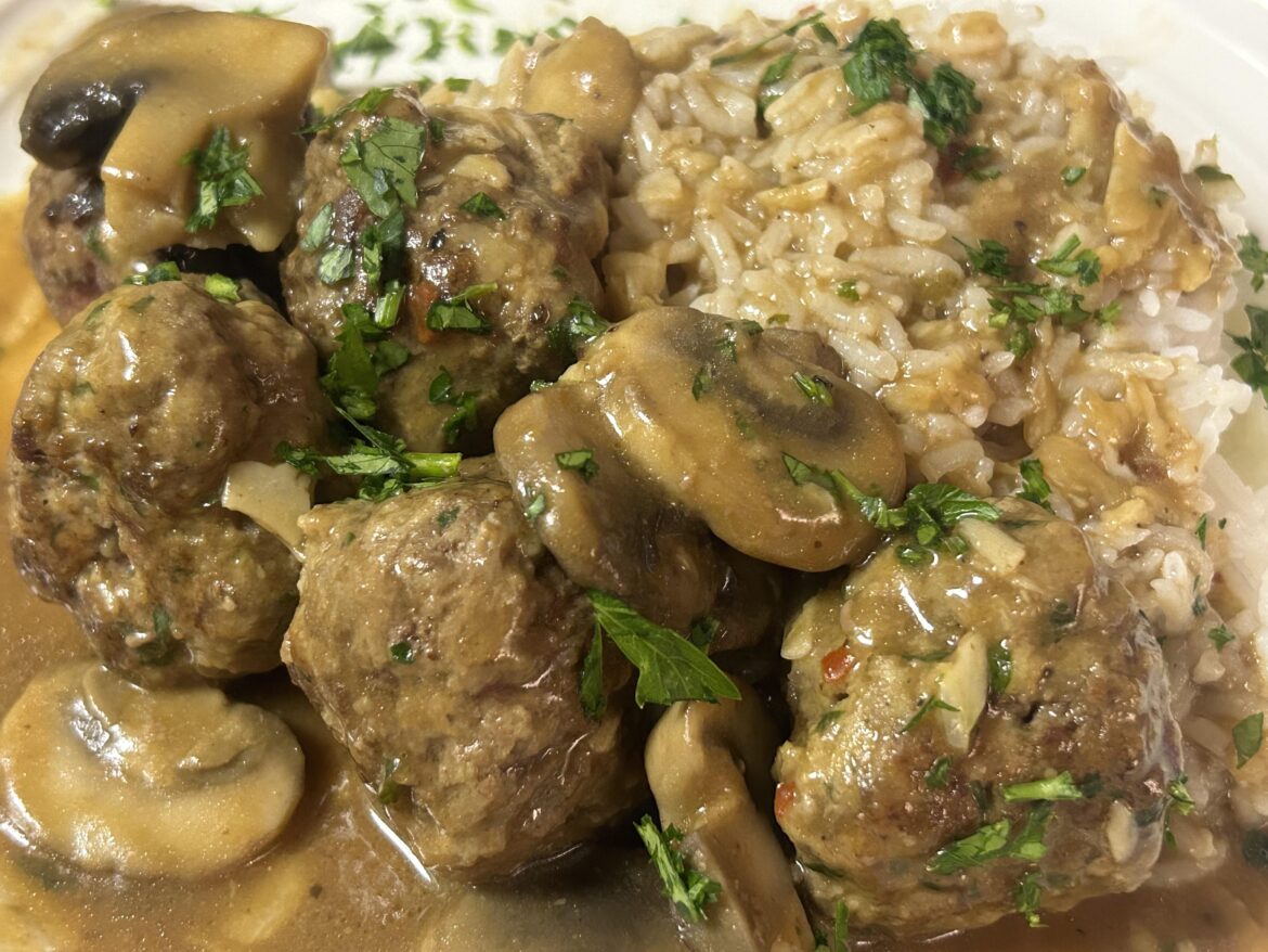 Meatballs, mushrooms, and gravy, with rice.