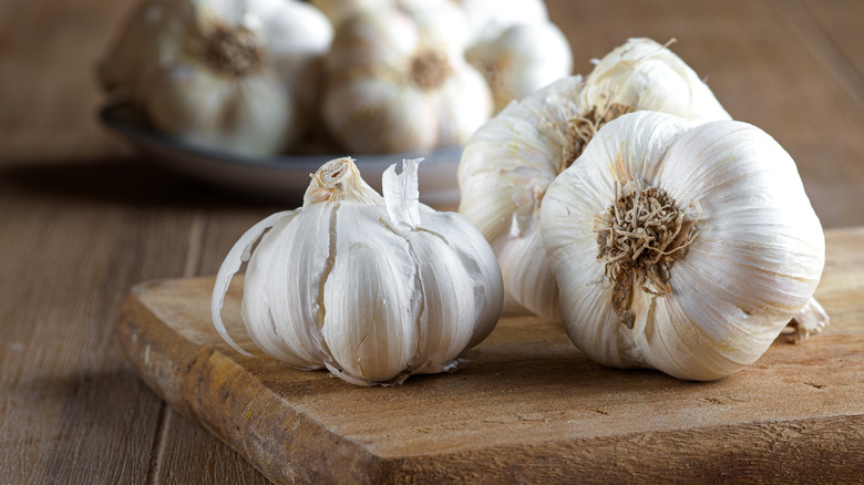 Fresh garlic bulbs on a cutting board