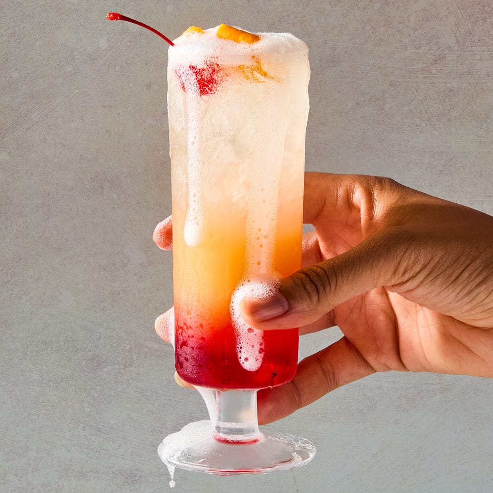sparkling tequila sunrise with a cherry and orange peel