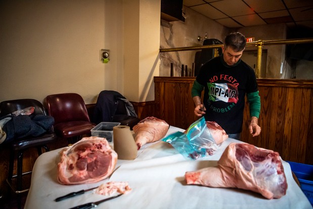 Patrick Dicicco prepares the leg of a pig during a prosciutto-making class. 