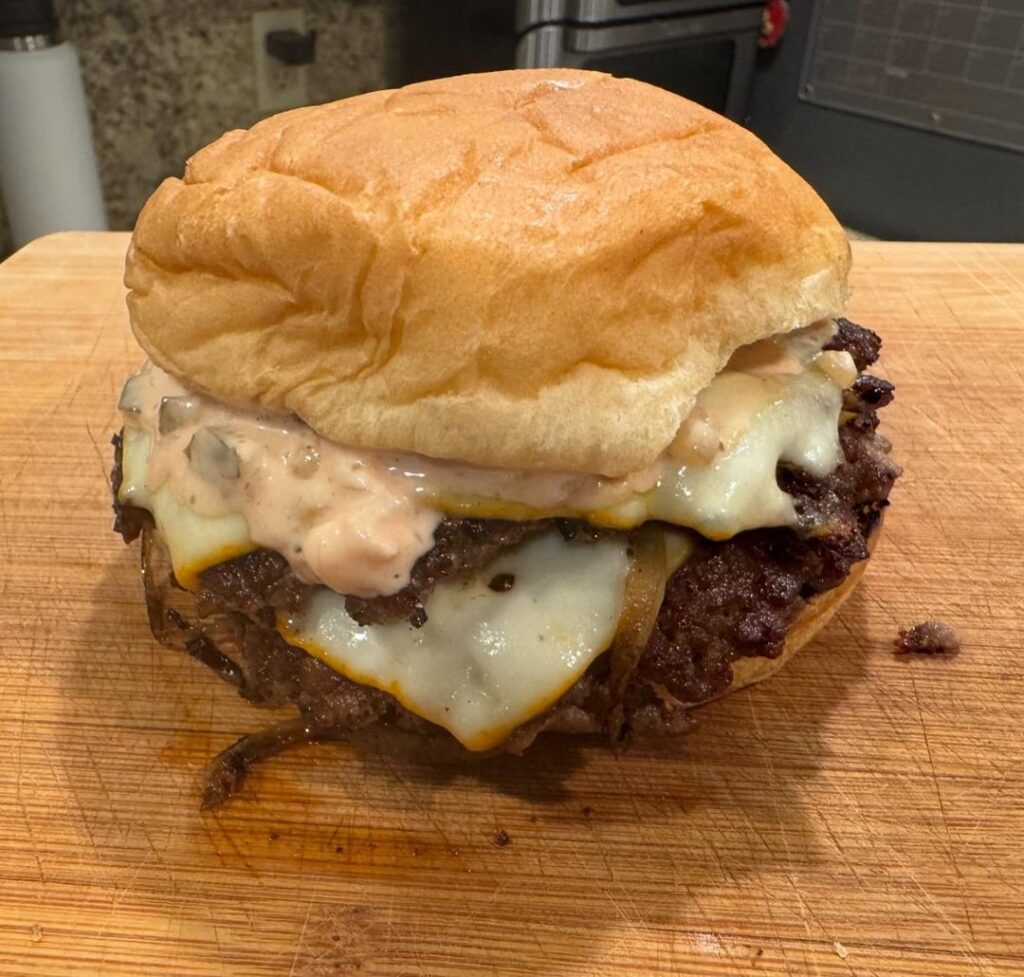 Double cheeseburger with muenster, thousand island, and onions