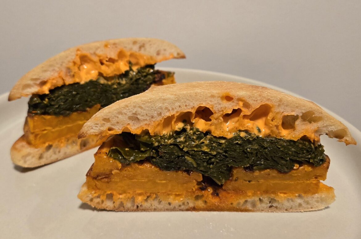 Roasted Sweet Potato and Collard Green Sandwich on Ciabatta with Red Pepper Mayo and Lao Gan Ma Chili Crisp Roasted Sweet Potato and Collard Green Sandwich on Ciabatta with Red Pepper Mayo and Lao Gan Ma Chili Crisp
