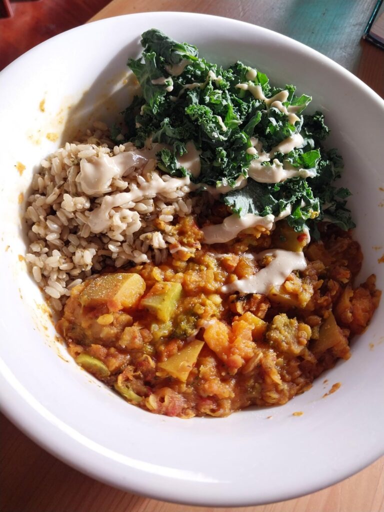 Red lentil pumpkin dahl with rosemary rice, kale and tahini
