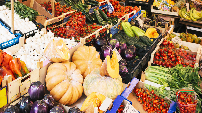Food in an italian market pumpkin, tomatoes, celery, eggplant, bananas and more