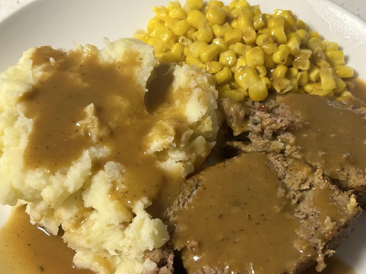 Meatloaf, mashed potatoes, corn, gravy.