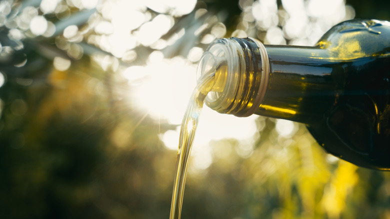 olive oil pouring out of a bottle