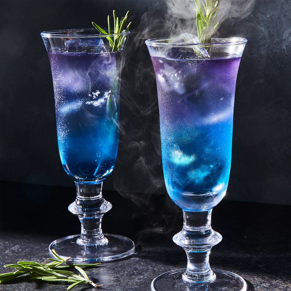 purple and blue layered drink with rosemary