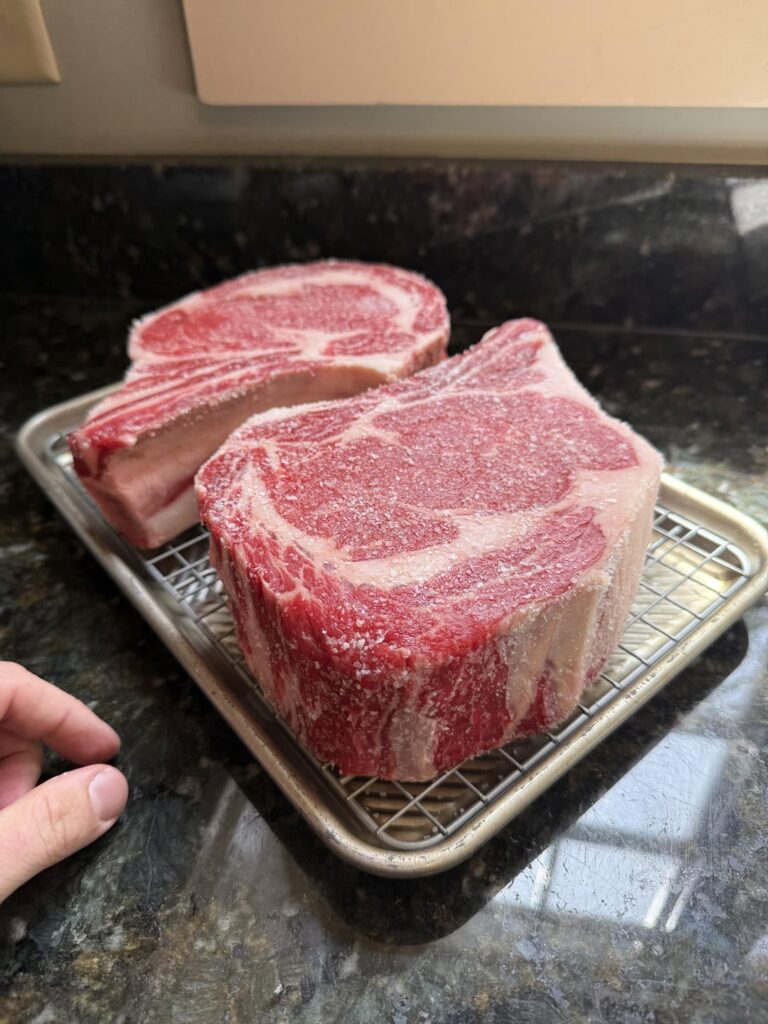 Couple of big guys on an open fire.