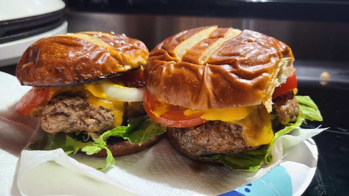 Cheeseburgers on pretzel buns