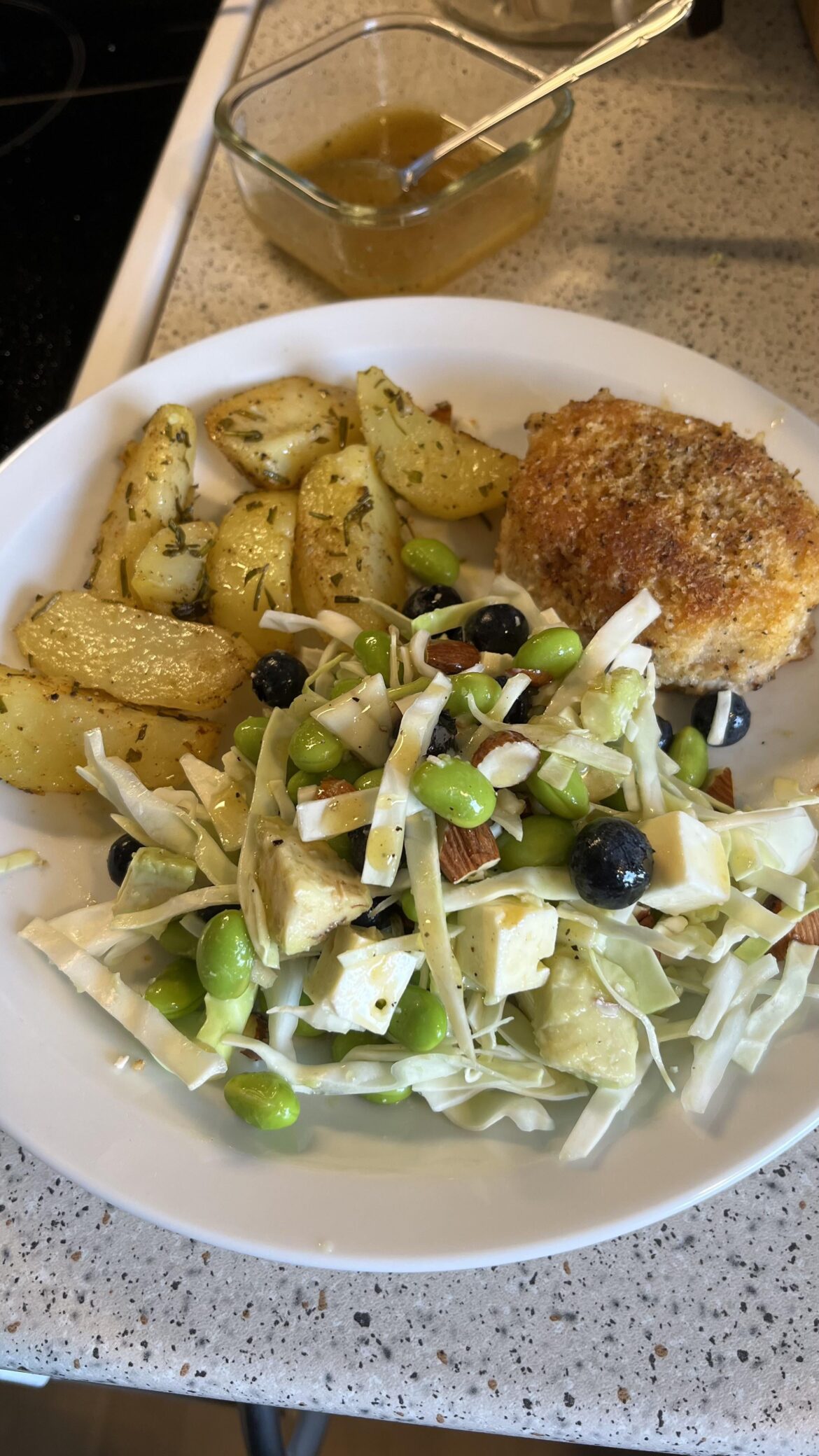 Chicken patty, oven roasted potatoes and a pointy cabbage salad